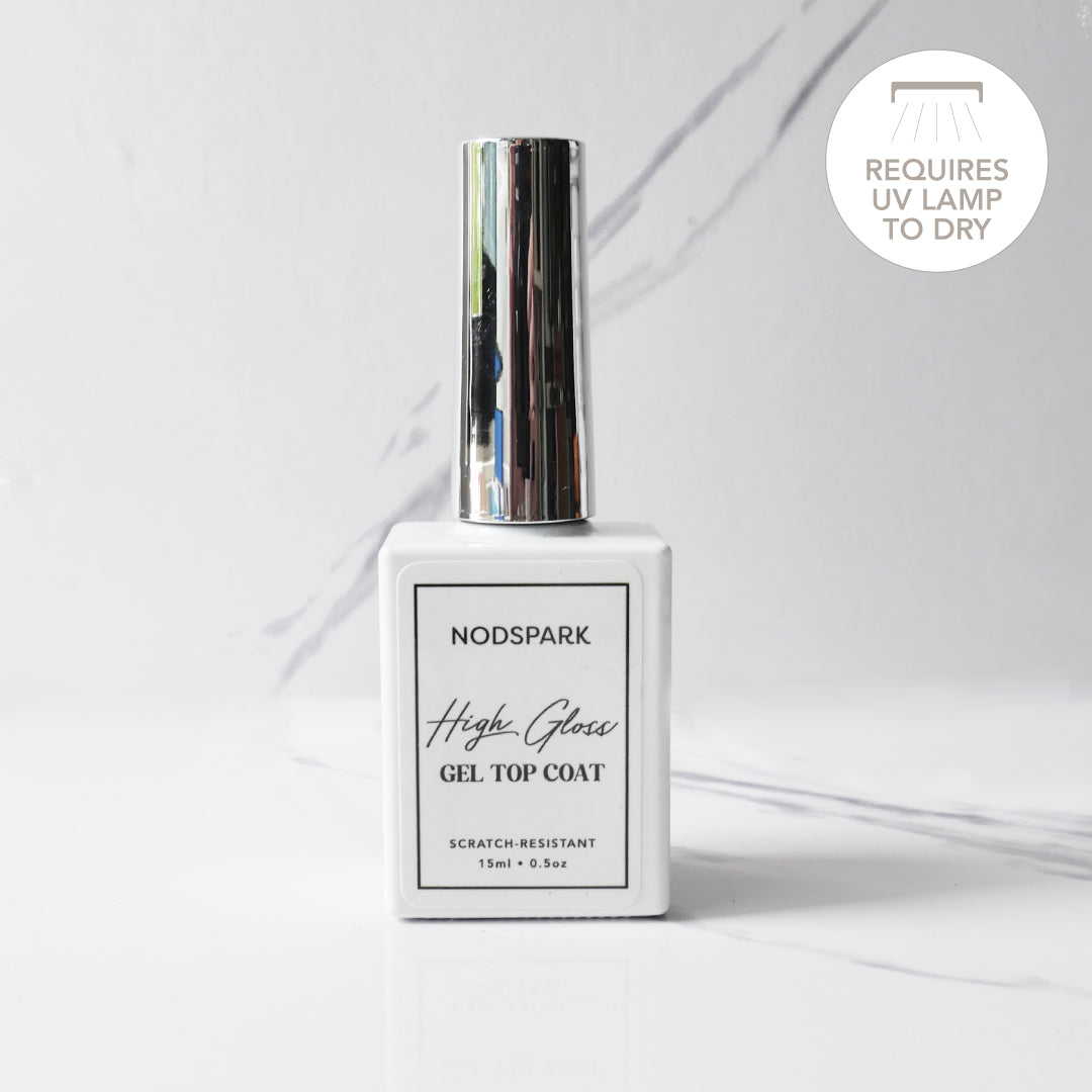 Square clear bottle of Nodspark High Gloss Gel Top Coat with a silver cap set against a light background with subtle line accents.