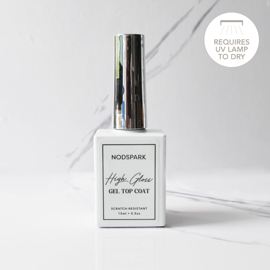 Square clear bottle of Nodspark High Gloss Gel Top Coat with a silver cap set against a light background with subtle line accents.