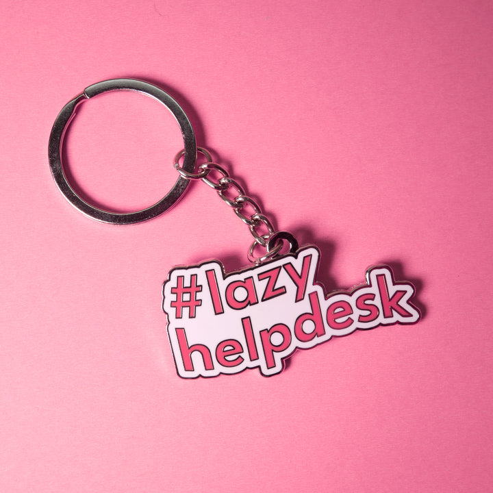 Pink bold typography keychain featuring "#lazyhelpdesk" displayed on a bright pink background.