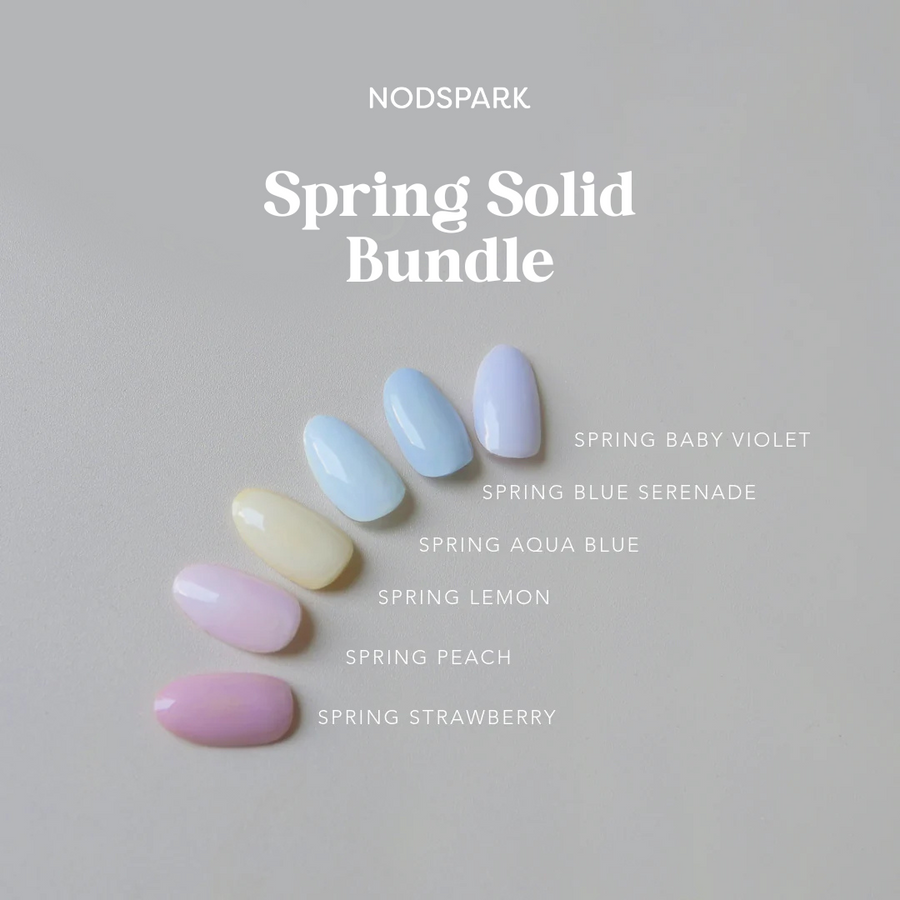 A fan arrangement of pastel-colored nail swatches showcasing the Spring Solids collection against a light grey background.