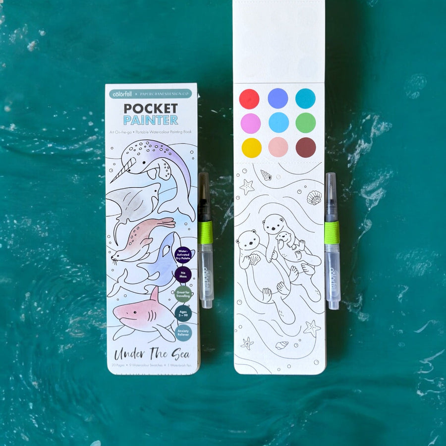 Under The Sea pocket painter watercolor painting kit featuring an ocean-themed coloring booklet and paint palette cards on a textured teal background.