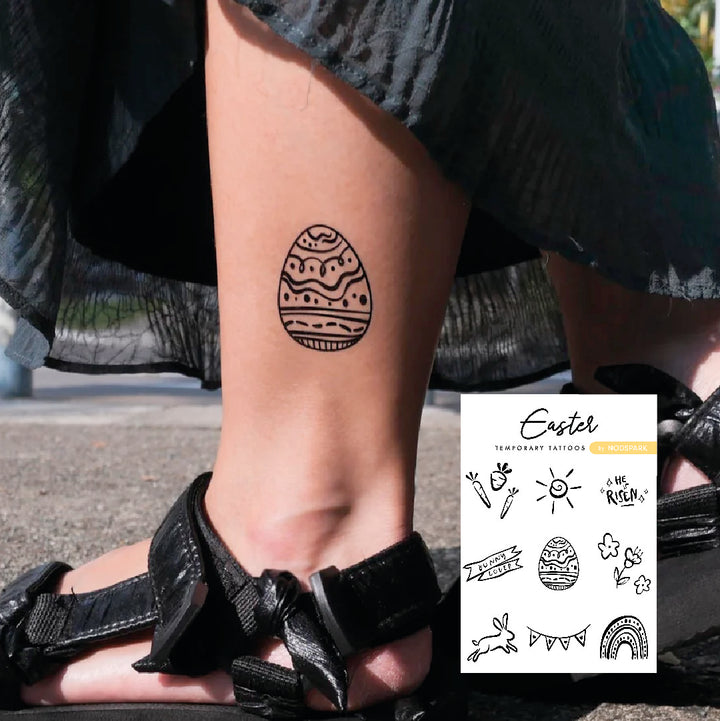 Black-line patterned egg temporary tattoo applied near the ankle, accompanied by an inset preview of the monochrome sheet.