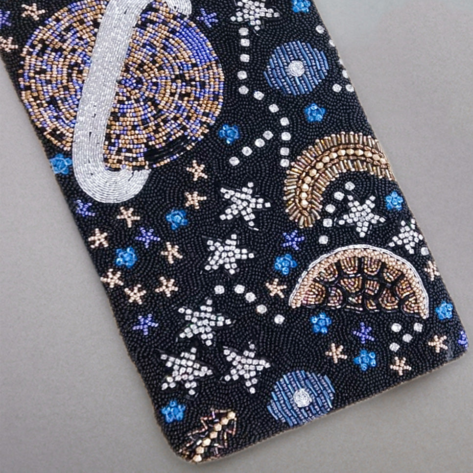 Black rectangular clutch intricately hand-beaded with a celestial space motif featuring planets, stars, and crescent moons in blue, silver, and gold beads.